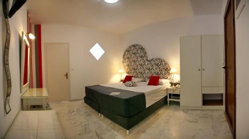a bedroom with a bed and a desk in it at Sunset Hotel in Petra
