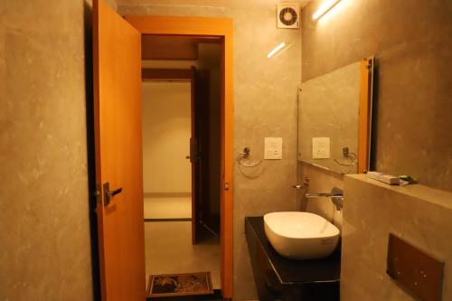 a bathroom with a toilet and a sink and a mirror at Ananda Castle in Vrindāvan