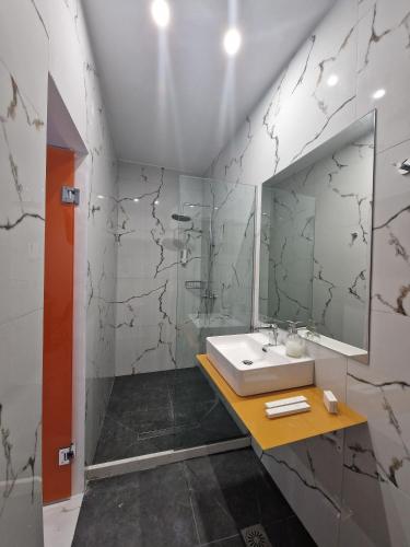 a bathroom with a sink and a mirror at City Center Studios by Cretan Houses in Heraklio