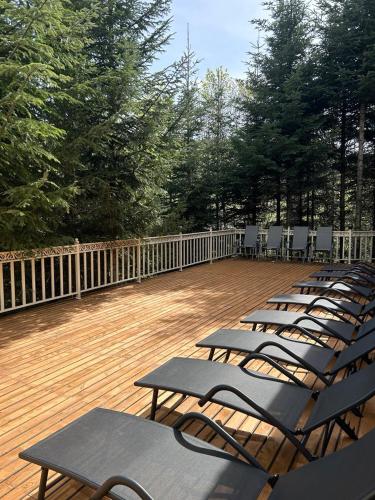 a row of chairs and tables on a deck at Idylia Grand Villas in Migovo