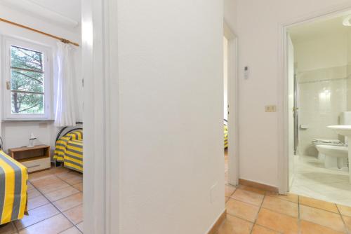 a bathroom with a sink and a toilet in a room at Residence Le Mimose in Procchio