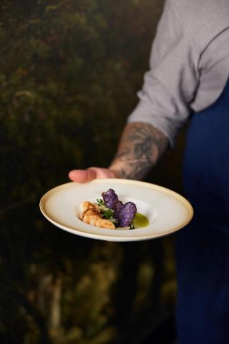 a person holding a plate with food on it at Van der Valk Hotel Amsterdam - Amstel in Amsterdam