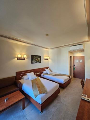 Ένα ή περισσότερα κρεβάτια σε δωμάτιο στο Princessa Hotel