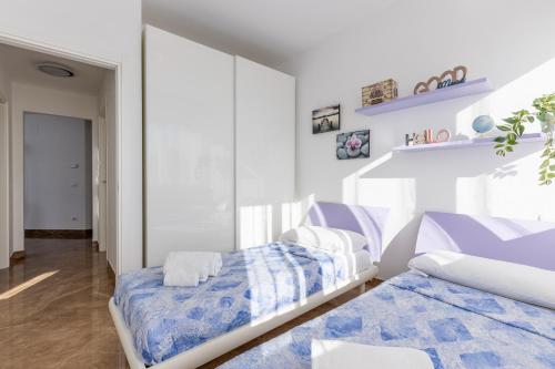 a bedroom with two beds and a mirror at Seaside Apartment with swimming pool and parking in Calambrone
