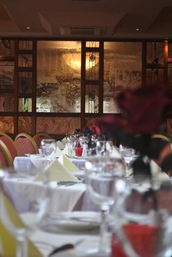 a long table with white table cloths on it at Shap Wells Hotel in Shap