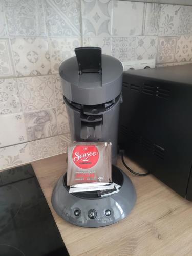 a coffee maker with a box on top of it at Die Sonne Nollingen in Nollingen