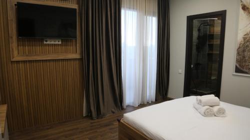 a hotel room with a bed with towels on it at Golden Sun Kobuleti in K'obulet'i