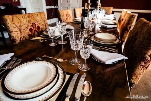 a wooden table with plates and wine glasses on it at Ash Hill B & B in Kilmallock