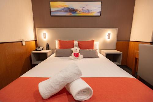 a hotel room with a bed with towels on it at YEHS Hotel Sydney QVB in Sydney