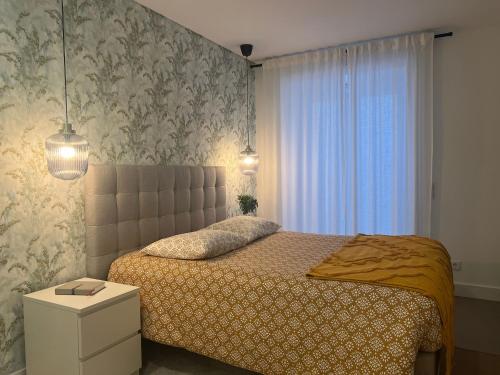 a bedroom with a bed and a window at Coração do Castelo AL in Castelo Branco