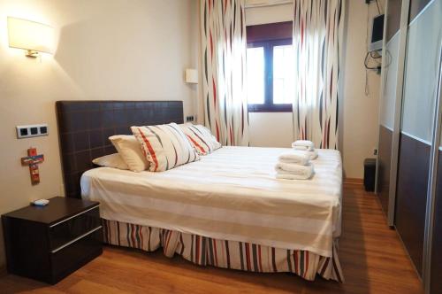 sypialnia z łóżkiem z ręcznikami w obiekcie Carabeo 1-30 w mieście Nerja