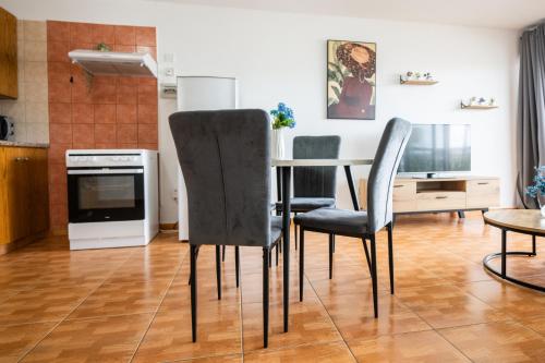 a kitchen with a dining room table and chairs at Napa Centrale Suites in Ayia Napa