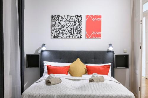 a bedroom with a bed with red and yellow pillows at Spacious apartment in Graz for 6 people in Graz
