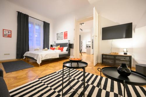a living room with a bed and a tv at Spacious apartment in Graz for 6 people in Graz