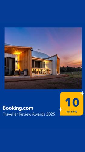 a building with a sunset in the background at Benbullen Retreat in Angaston