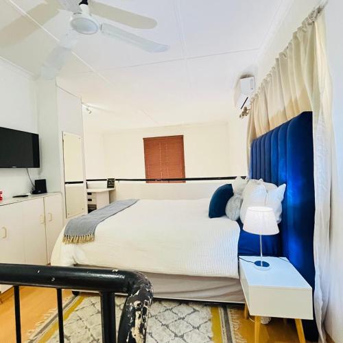 a bedroom with a large bed with a blue canopy at Royal Classic Apartments in Durban