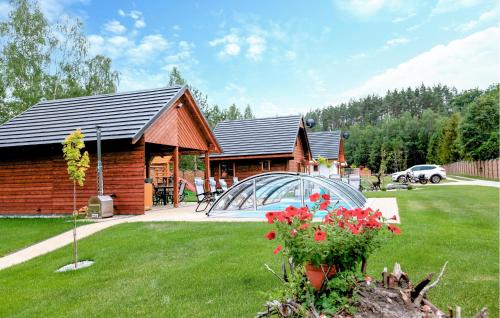 a log cabin with a greenhouse in a yard at Stunning Home In Jamno With Sauna in Jamno