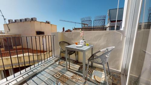 a balcony with a table and chairs on a balcony at Myflats Old Corner in Alicante