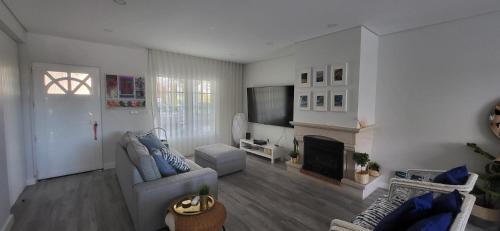 a living room with a couch and a fireplace at Beach House Altura in Altura