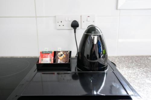 a black vase sitting on top of a glass table at Napa Centrale Suites in Ayia Napa