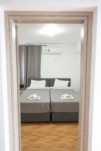a bedroom with a bed with two plates on it at Napa Centrale Suites in Ayia Napa