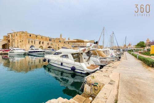 a group of boats are docked in a harbor at Authentic studio with Maltese Balcony in Bormla by 360 Estates in Taʼ Penza