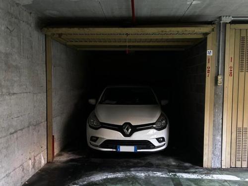 a white car is parked in a garage at DesenzanoLoft Official Partner Homes & Villas by Marriott Bonvoy - H2o inside green residence with 3 pools in Desenzano del Garda