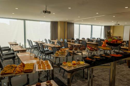 a room with tables filled with different types of food at ibis Styles Istanbul Kurtkoy in Istanbul
