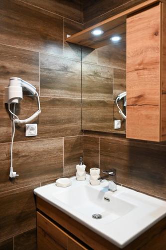 a bathroom with a white sink and a mirror at Zeleni vrh A03 in Kopaonik
