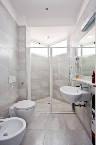 a bathroom with a toilet and a sink and a shower at Hotel Croce di Malta e Mexico in Cesenatico
