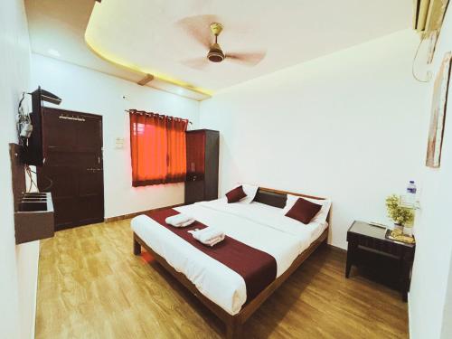 a bedroom with a bed and a ceiling at Samudrasneha Resort in Nagaon