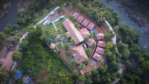 an aerial view of a house with trees at Poliyam Thuruth Eco Tourism Village in Kāsaragod