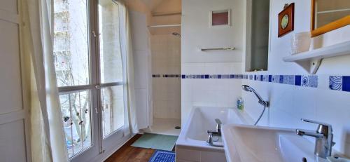 a bathroom with a sink and a window at Spacious apartment 4 people parking, bright in Aix-en-Provence