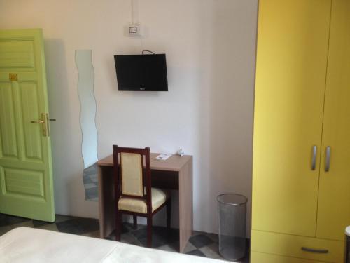 a room with a desk and a television on a wall at B&B L'Alba in Gagliato