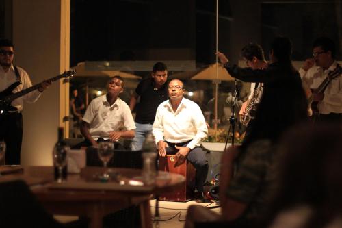 a group of people sitting in a room with a microphone at Casa Andina Standard Chincha in Chincha Alta