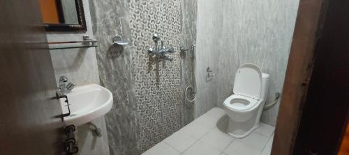 a bathroom with a toilet and a sink at Hotel August International in Pokhara