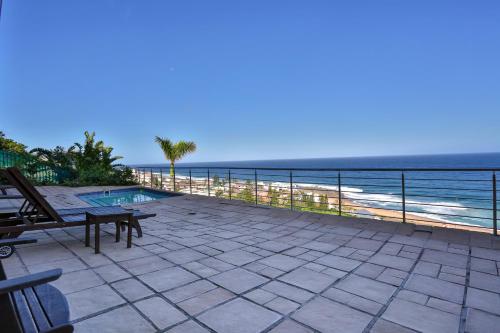 a patio with a view of the ocean at Zimbali View Eco Guesthouse in Ballito