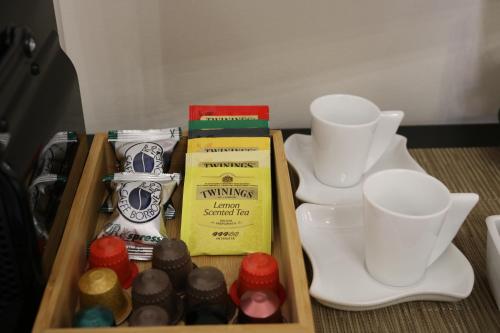 a wooden tray with cups and chocolates on a table at B&B San Pancrazio hotelHouse in Catania