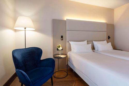 Postel nebo postele na pokoji v ubytování NH Geneva Airport Hotel