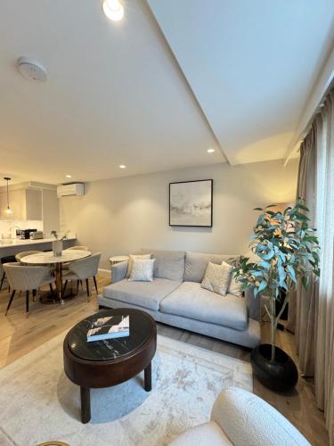 a living room with a couch and a table at Comfort 3 Bedroom Home in Notting Hill in London