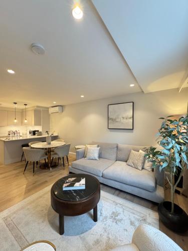 a living room with a couch and a table at Comfort 3 Bedroom Home in Notting Hill in London
