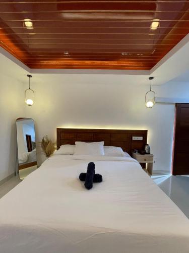 a bed with a stuffed animal sitting on top of it at Danu Kuning Villa in Kintamani