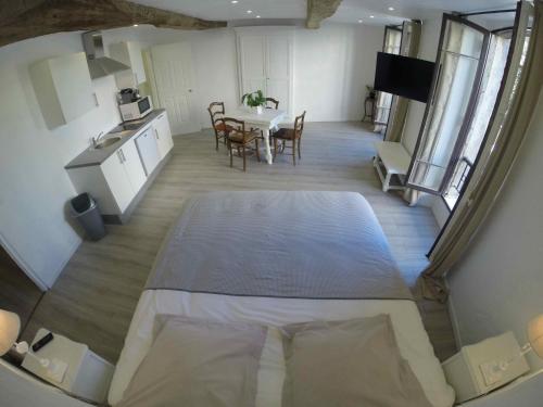 a kitchen and dining room with a large table in a room at Maison Carles BnB in La Colle-sur-Loup