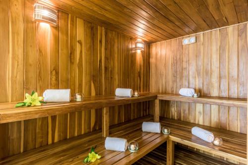a sauna with wooden walls and benches in a room at NH Collection Bogotá Royal Teleport in Bogotá