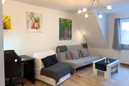 a living room with a couch and a chair at Ferienwohnung Rode in Müden
