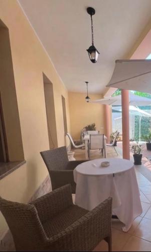 a dining room with a white table and chairs at Cozy house with terrace in Pula, 85 m², garden in Pula