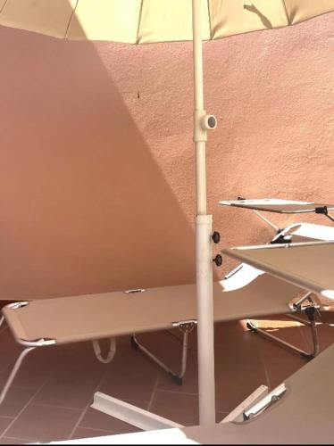 a white umbrella sitting on top of a table at Cozy house with terrace in Pula, 85 m², garden in Pula