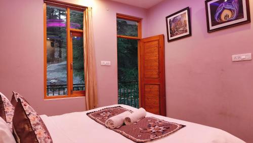 a bedroom with a bed with white sheets and a window at Lill Sparrow by Verdant escapes hospitality in Dharamshala