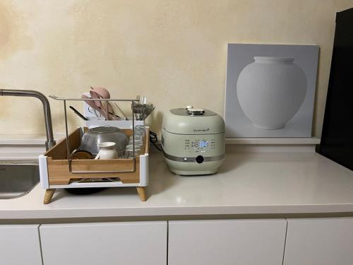 a kitchen counter with a mixer and a vase at Stay Ducksan in Suwon