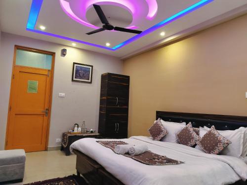 a bedroom with a bed with a purple ceiling at Lill Sparrow by Verdant escapes hospitality in Dharamshala